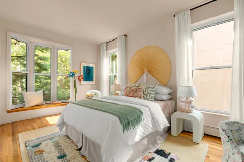 a bedroom with a bed and a window