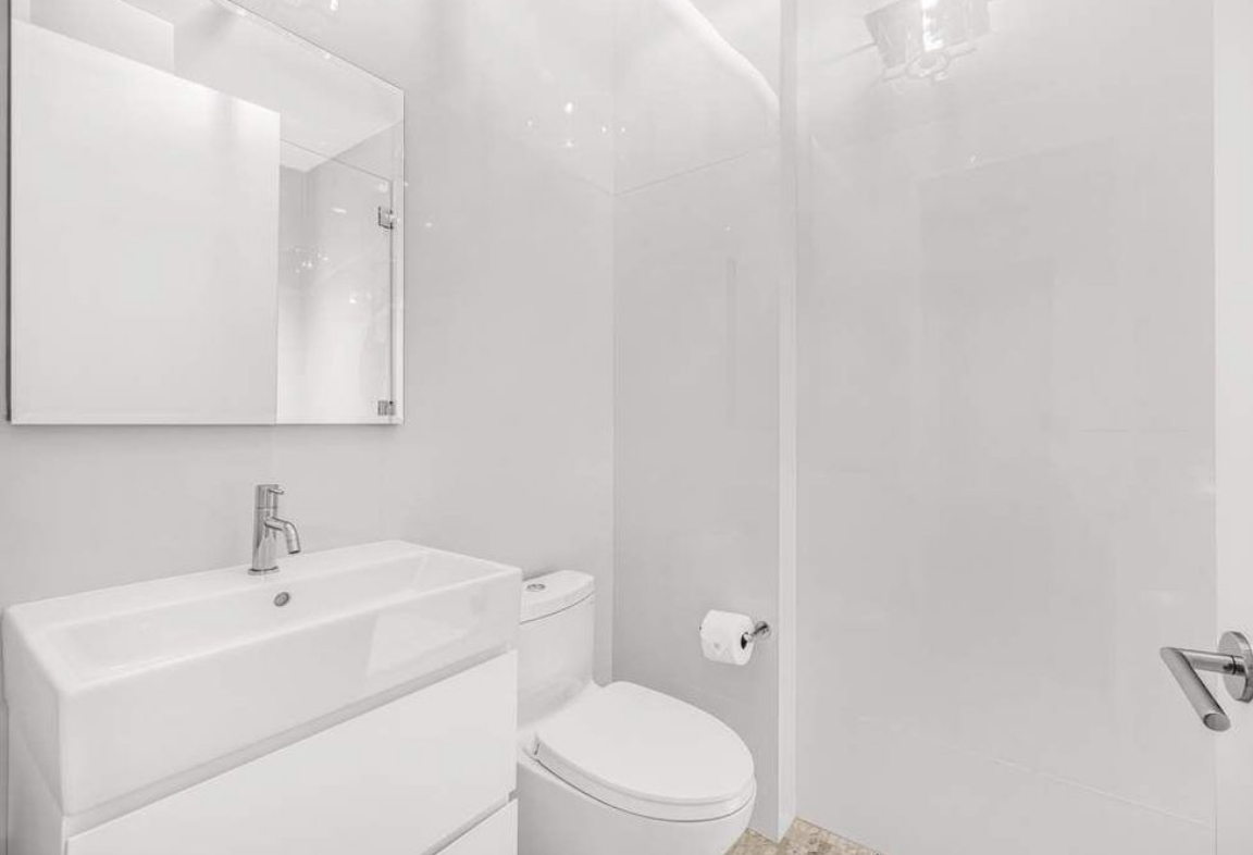 532 West 20th Street, Unit 4 Manhattan, NY 10011 - Photo 17 of 23 a white toilet sitting next to a bathroom sink