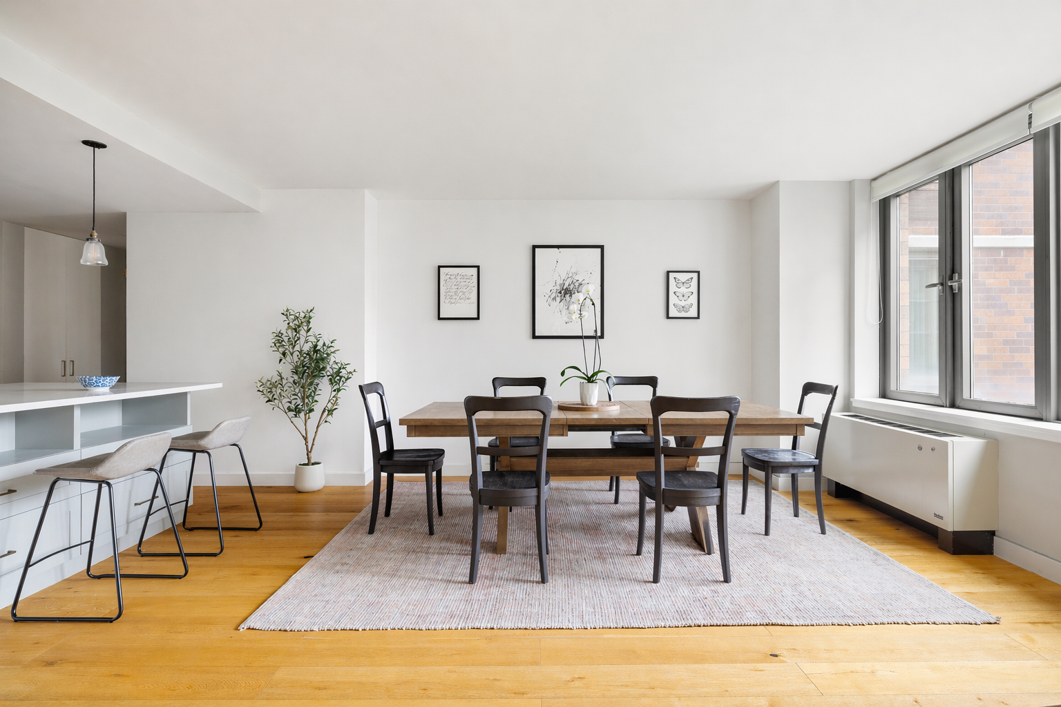 455 Main Street, Unit 4GH Manhattan, NY 10044 - Photo 2 of 9 a view of a dining room with furniture window and wooden floor