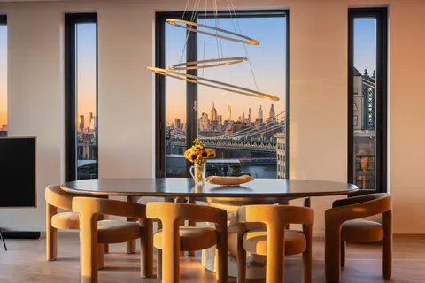 a view of a dining room with furniture and window