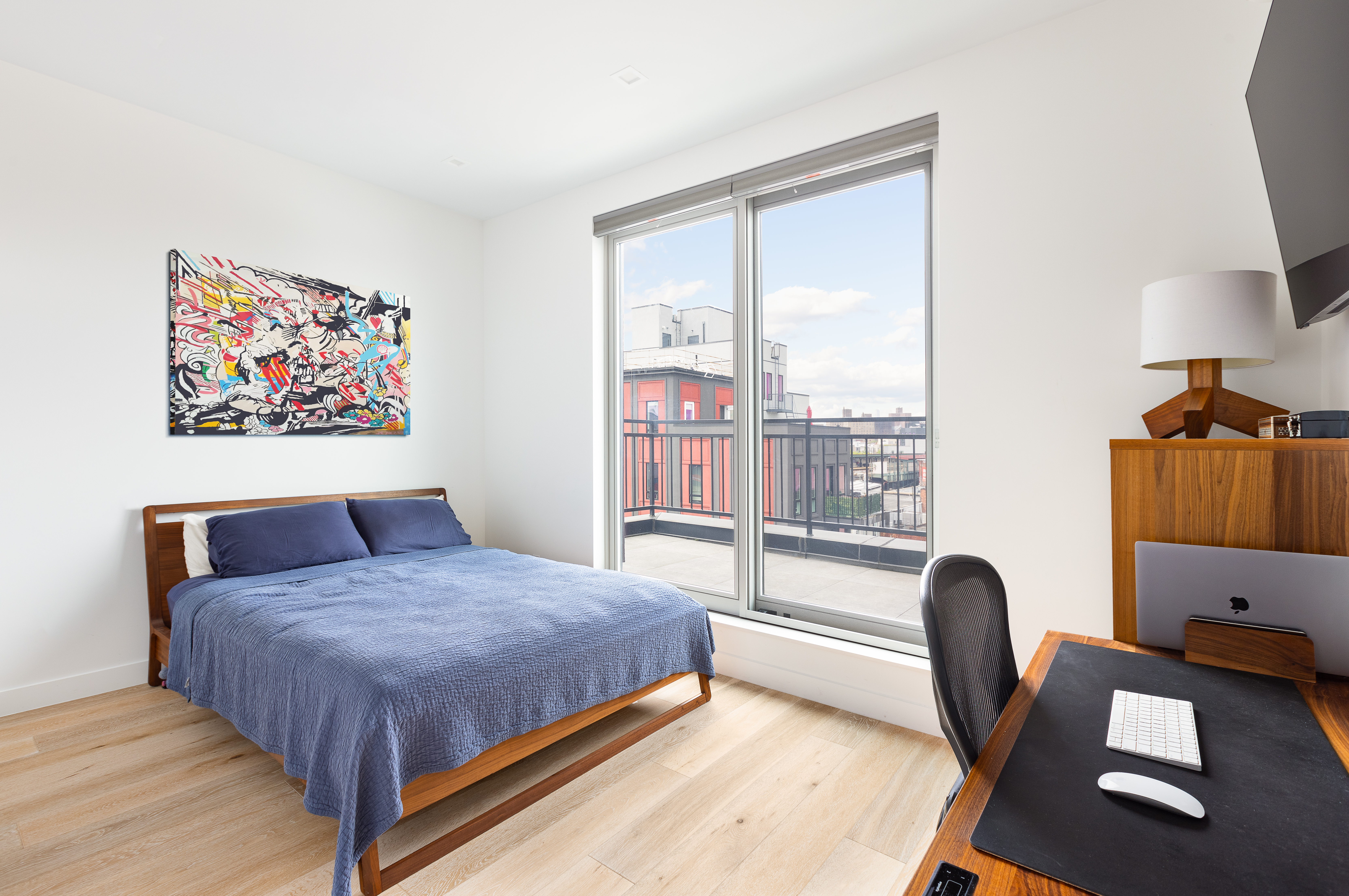 1122 Lafayette Avenue, Unit 4C Brooklyn, NY 11221 - Photo 4 of 14 a bedroom with a large bed a couch and a large window