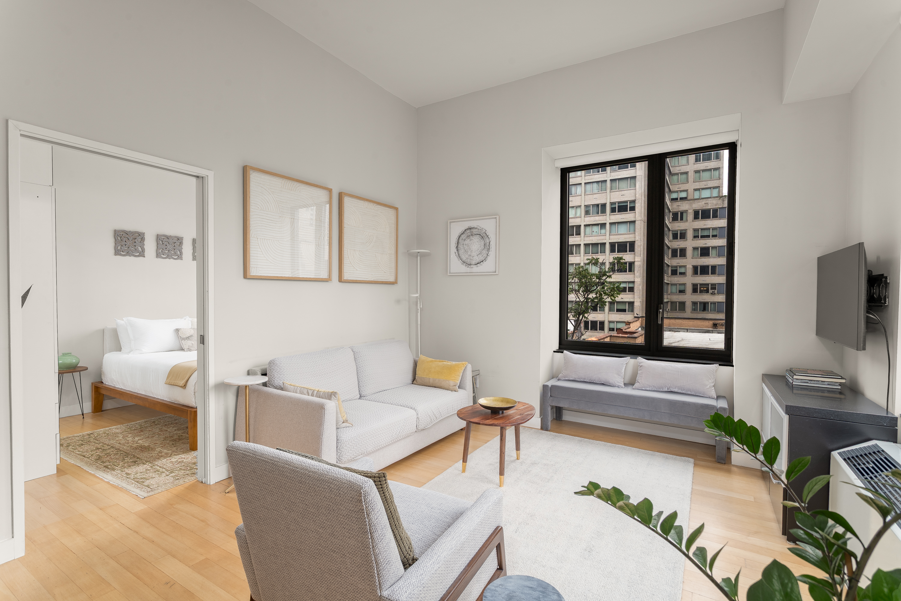 450 East 83rd Street, Unit 5K Manhattan, NY 10028 - Photo 2 of 16 a living room with furniture and a flat screen tv