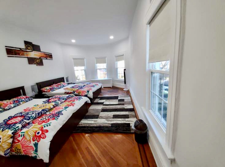 1112 Beverley Road Brooklyn, NY 11218 - Photo 50 of 53 a bedroom with bed and wooden floor