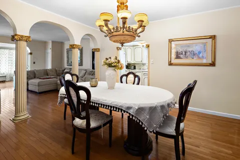 a view of a dining room with furniture wooden floor and a chandelier