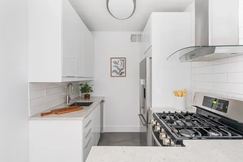 a kitchen with sink a stove and refrigerator