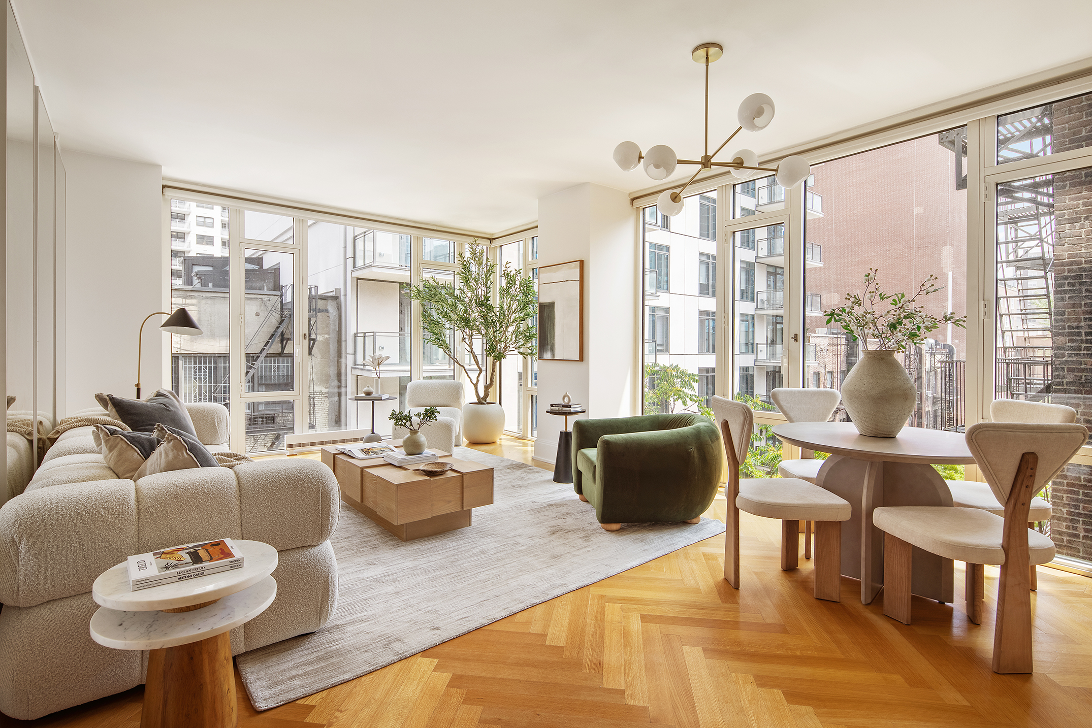 a living room with furniture a flat screen tv and a large window