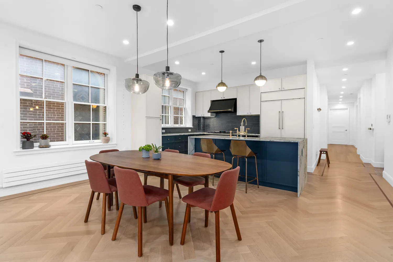 a kitchen with kitchen island a dining table and chairs