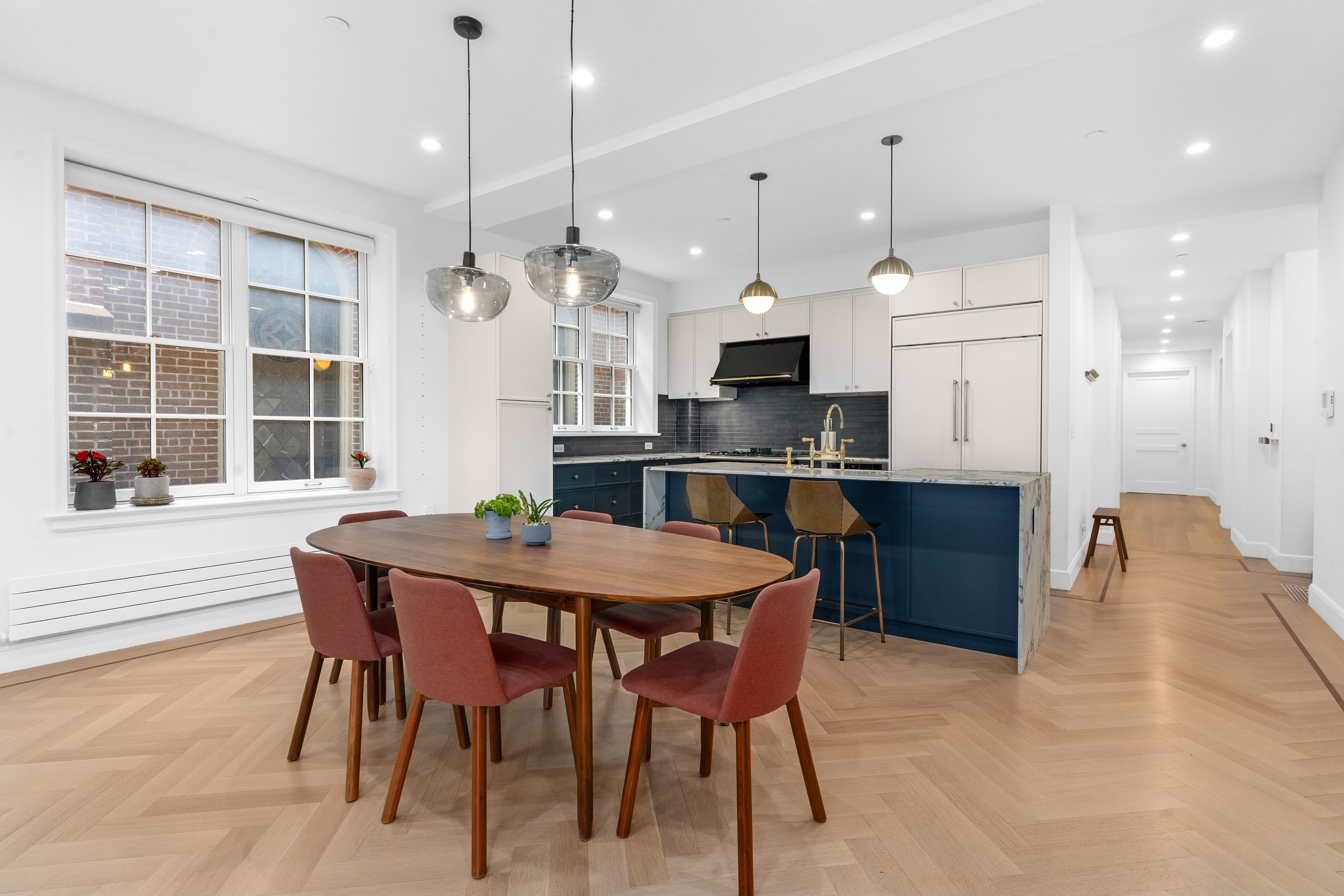 155 Noble Street, Unit 2 Brooklyn, NY 11222 - Photo 2 of 15 a kitchen with kitchen island a dining table and chairs