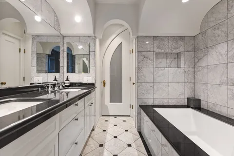 a large bathroom with a bathtub and a sink