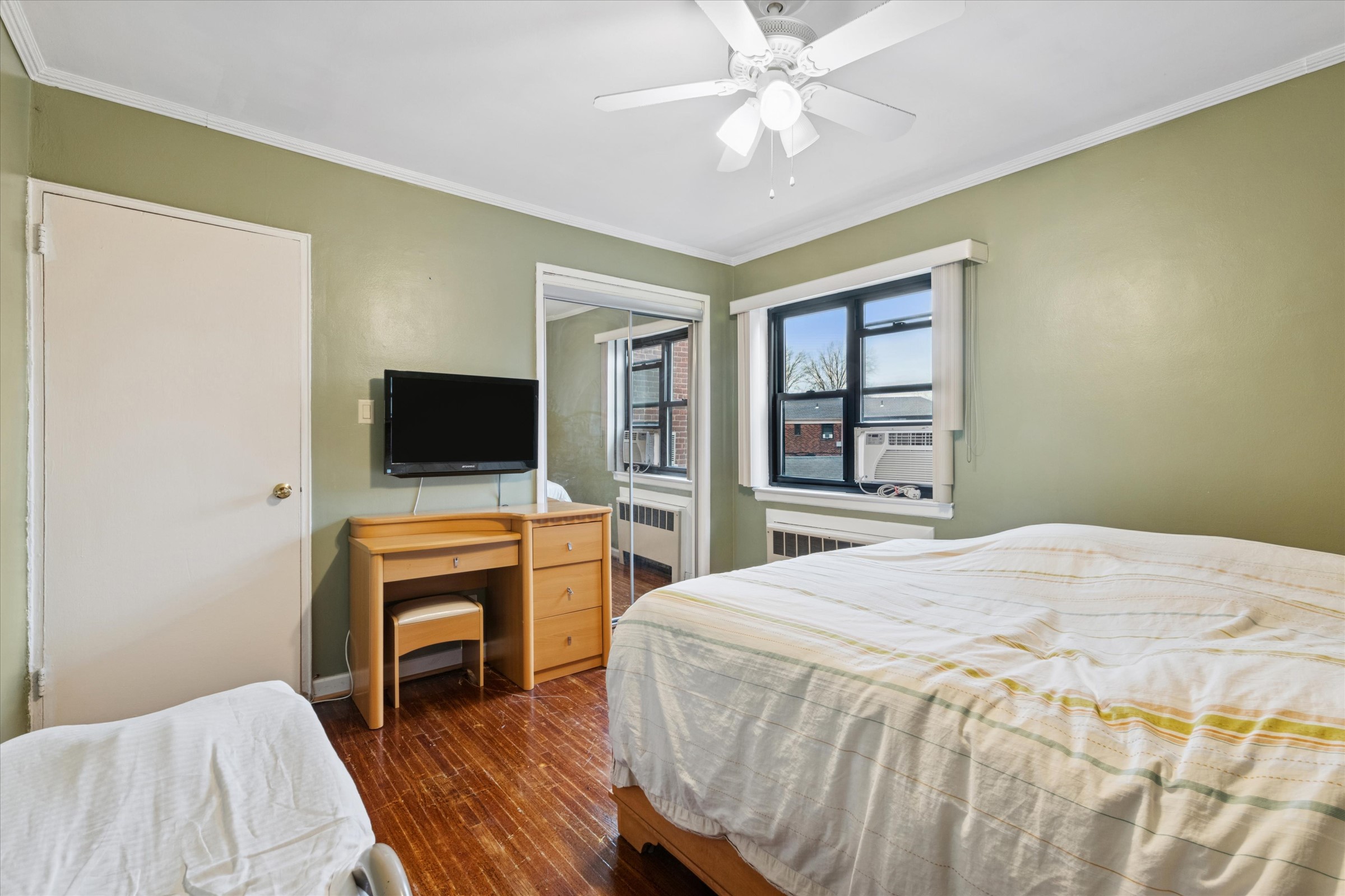 74-22 220th Street Oakland Garden, NY 11364 - Photo 7 of 16 a bedroom with a bed and a flat screen tv