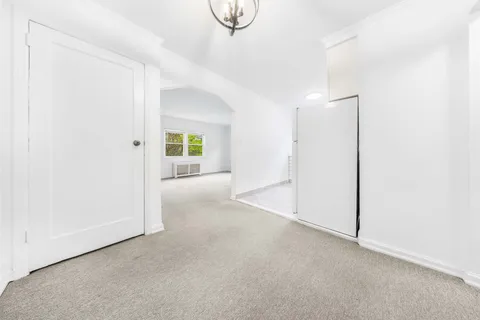 a view of livingroom and hall with wooden floor