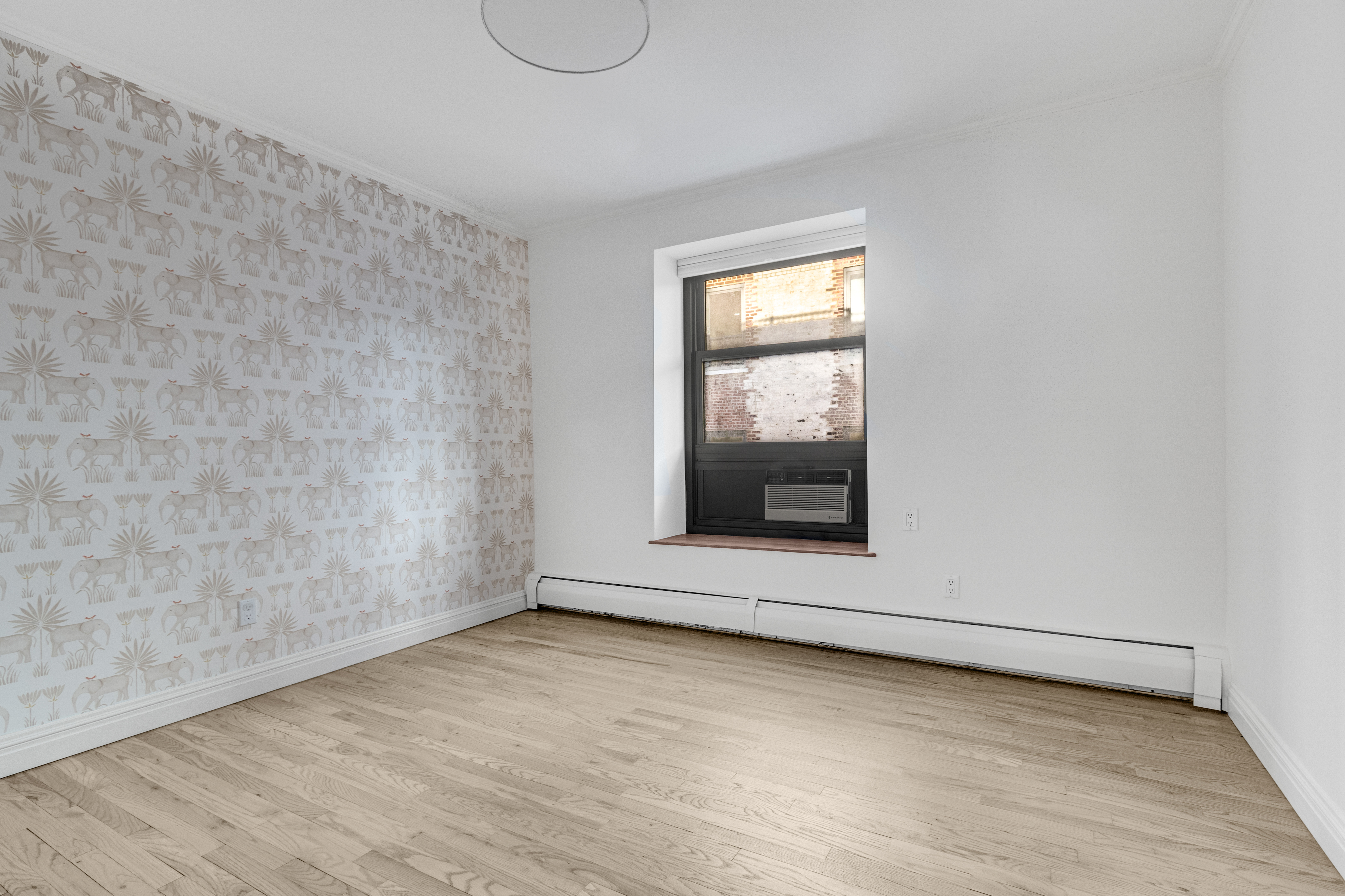 305 West 98th Street, Unit 7CS Manhattan, NY 10025 - Photo 10 of 18 a view of an empty room with wooden floor and a window