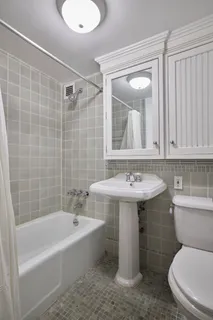 a bathroom with a sink a toilet and bathtub
