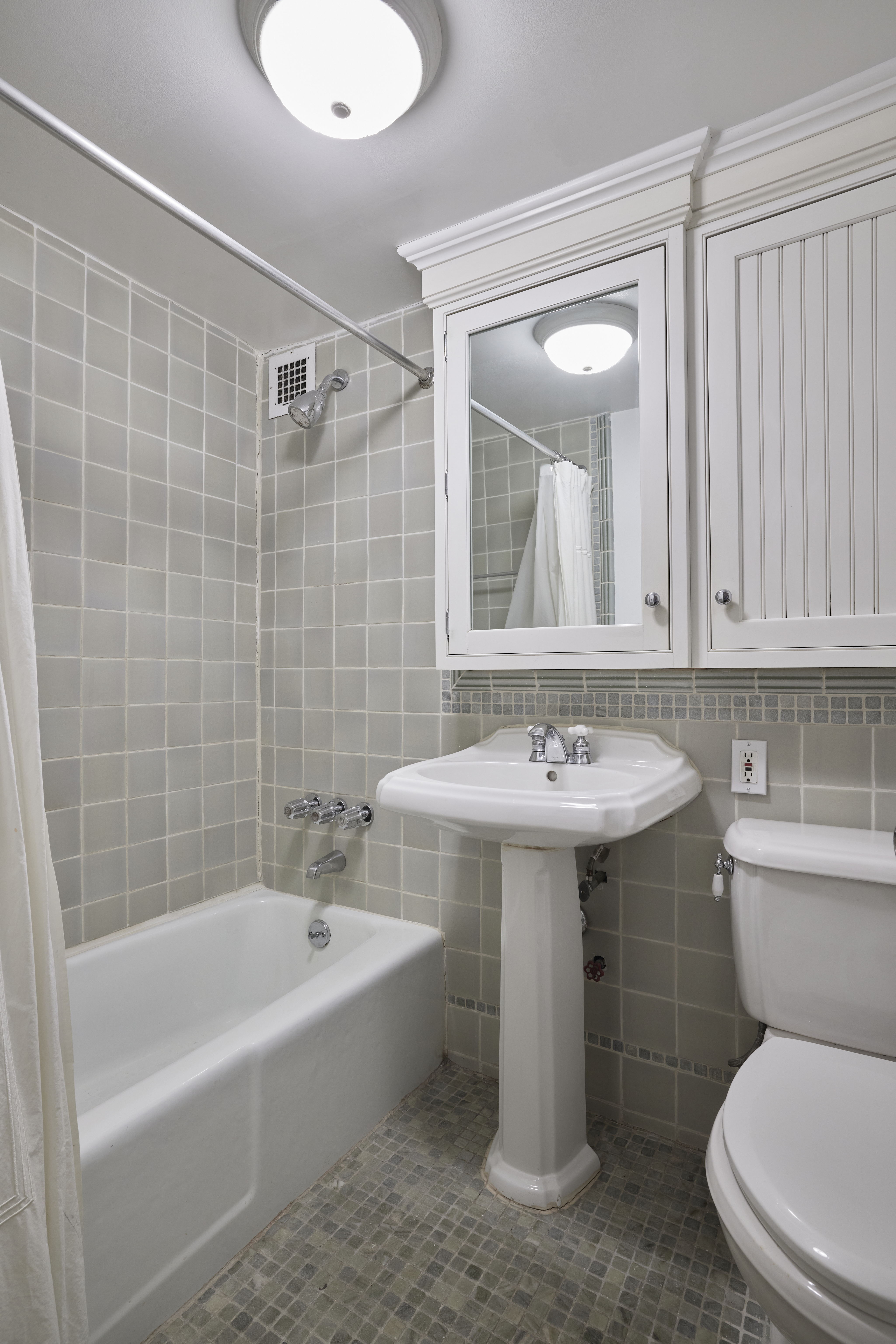 211 Thompson Street, Unit 5L Manhattan, NY 10012 - Photo 6 of 7 a bathroom with a sink a toilet and bathtub