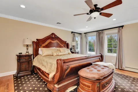 a bedroom with a bed and wooden floor