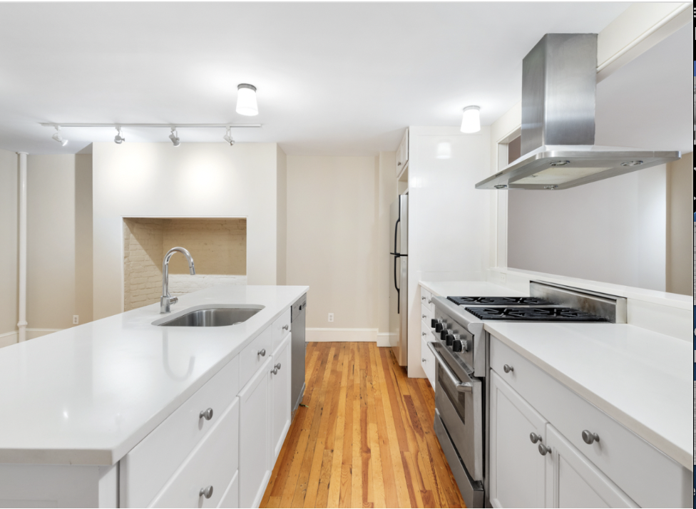 128 State Street, Unit GARDEN Brooklyn, NY 11201 - Photo 4 of 10 a kitchen with a sink a stove and cabinets