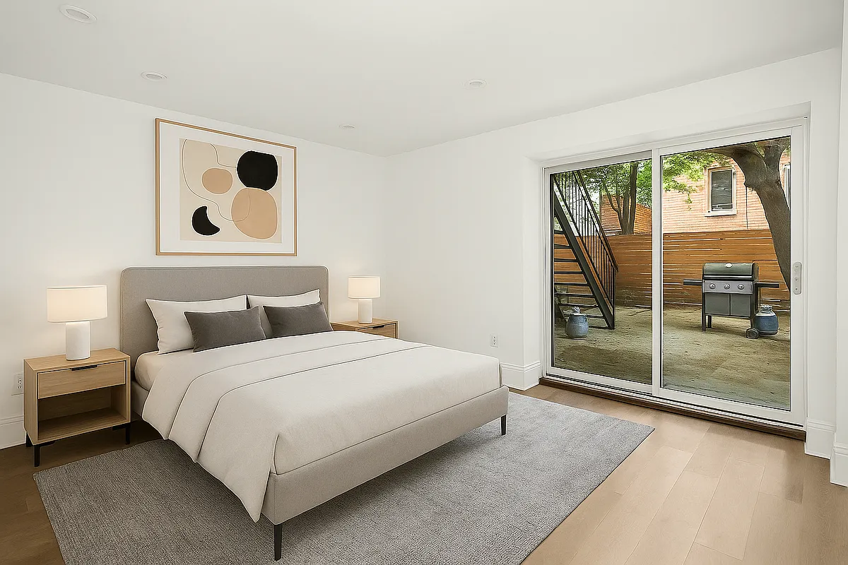 1316 Jefferson Avenue, Unit GDN Brooklyn, NY 11221 - Photo 3 of 6 a bedroom with a bed and a large window