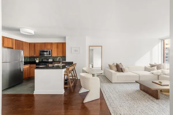 a living room with furniture and a kitchen
