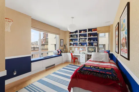 a room with a bed and a book shelf