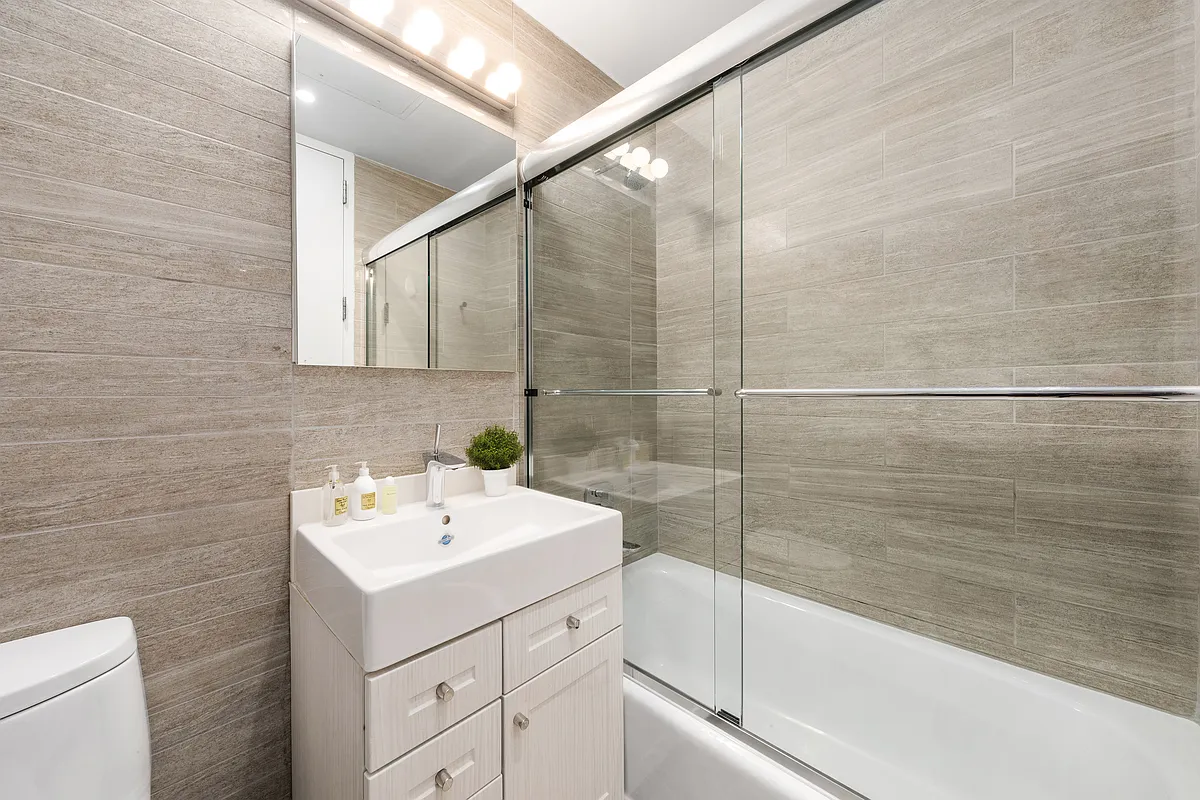 132 East 30th Street, Unit 2 Manhattan, NY 10016 - Photo 10 of 14 a bathroom with a sink and mirror