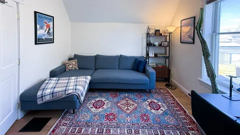 a living room with furniture and a rug