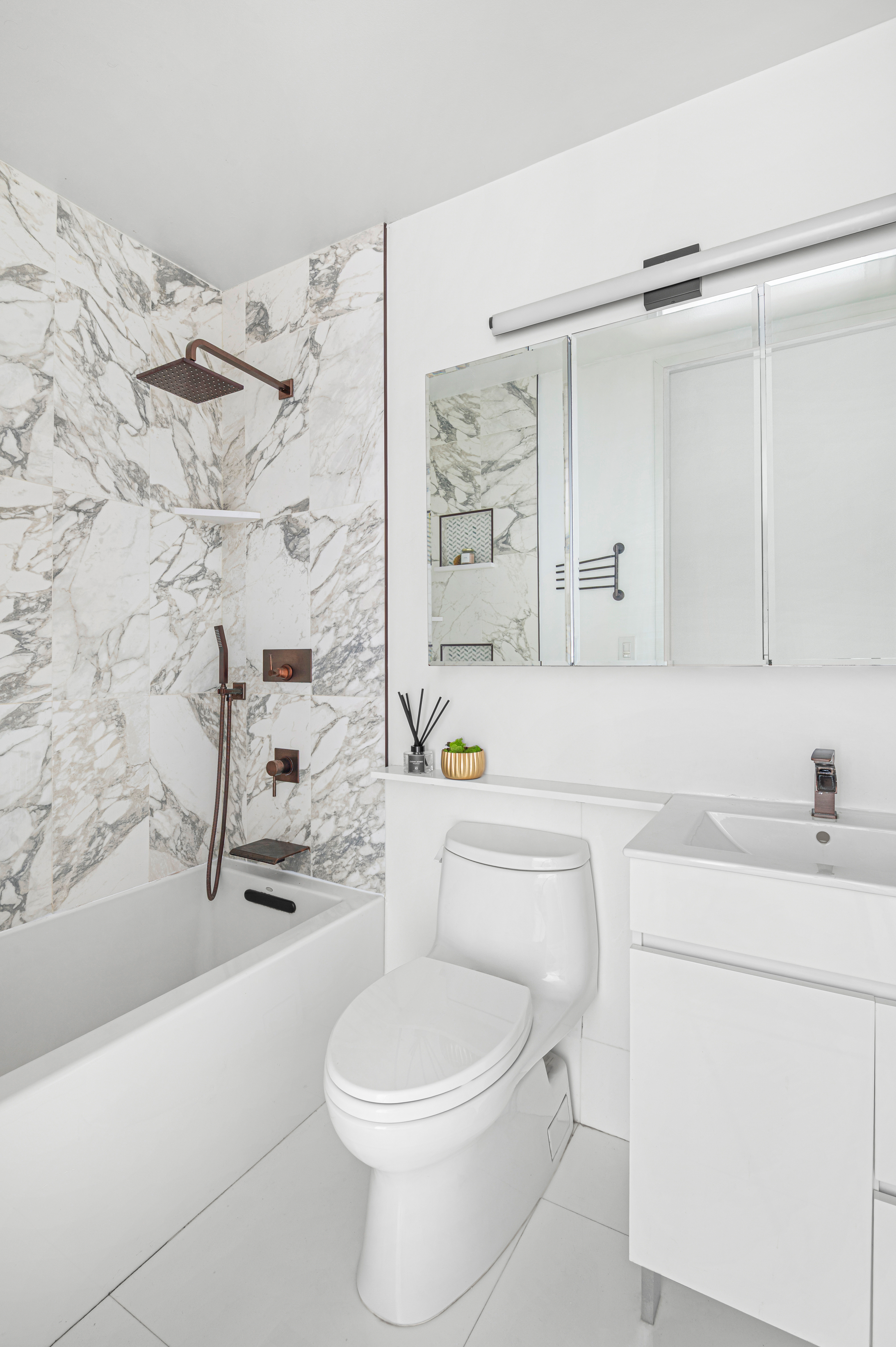 350 West 50th Street, Unit 29D Manhattan, NY 10019 - Photo 8 of 14 a bathroom with a sink a toilet and shower