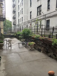 a view of a patio with table and chairs and potted plants