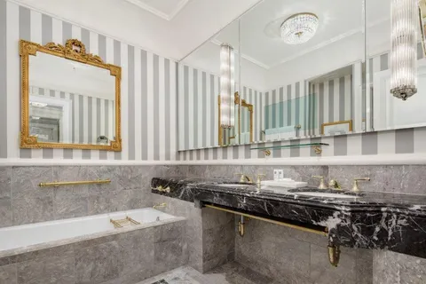 a bathroom with a granite countertop sink and a bathtub