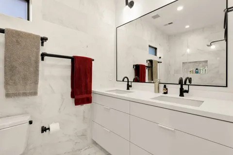 a bathroom with a double vanity sink and mirror