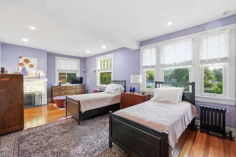 a bedroom with two beds and a large window
