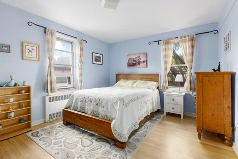 a spacious bedroom with a bed and a window