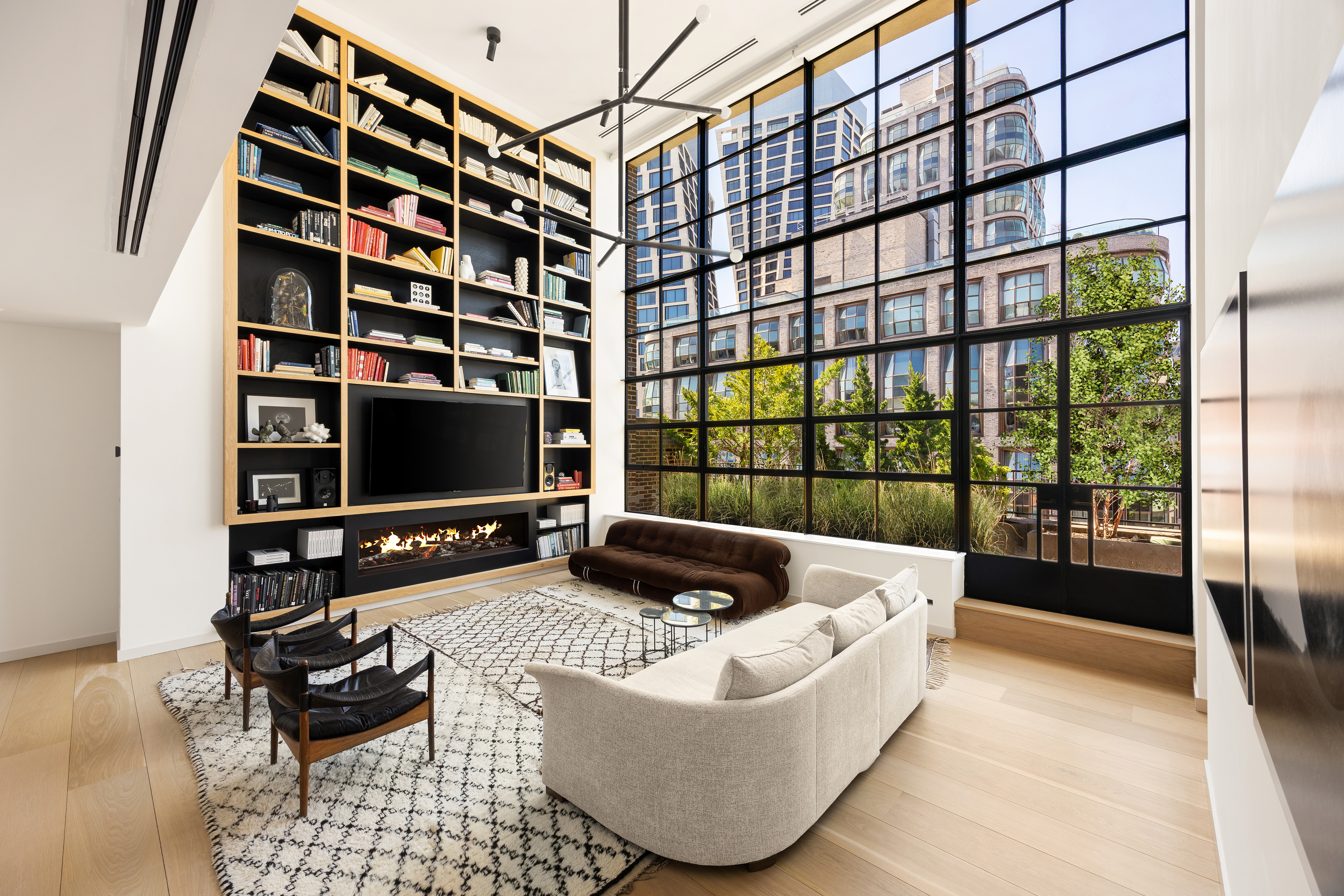 456 West 19th Street, Unit PHH Manhattan, NY 10011 - Photo 2 of 15 a living room with furniture and a flat screen tv