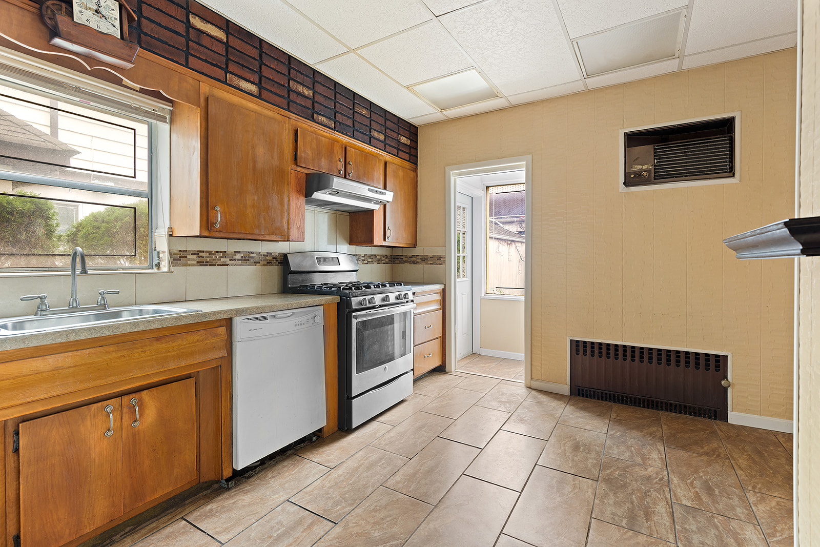 2411 Avenue M Brooklyn, NY 11210 - Photo 5 of 12 a kitchen with stainless steel appliances granite countertop a stove a sink and a microwave