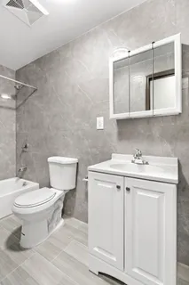 a bathroom with a sink toilet and mirror