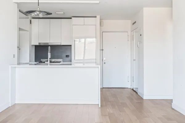 a view of kitchen with cabinets