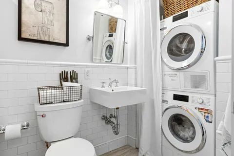 a bathroom with a toilet sink and mirror