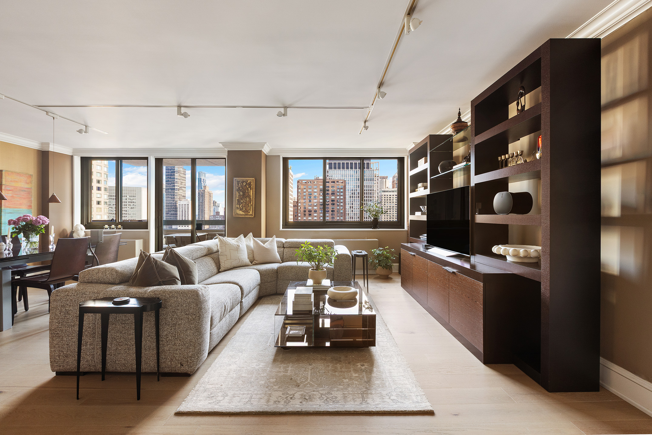 347 West 57th Street, Unit 25AB Manhattan, NY 10019 - Photo 2 of 21 a living room with furniture and a flat screen tv