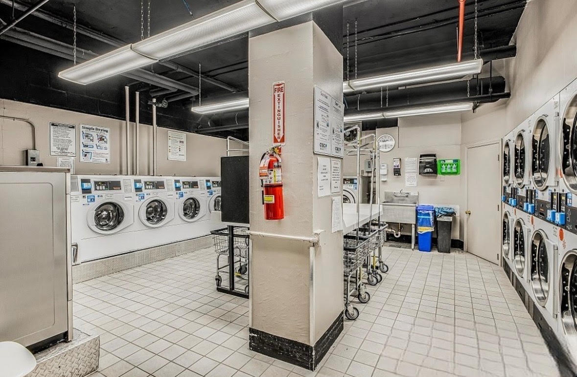 303 West 66th Street, Unit 2AE Manhattan, NY 10023 - Photo 14 of 15 a utility room with dryer and washer