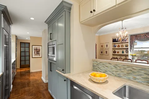 a bathroom with a granite countertop sink and a large mirror