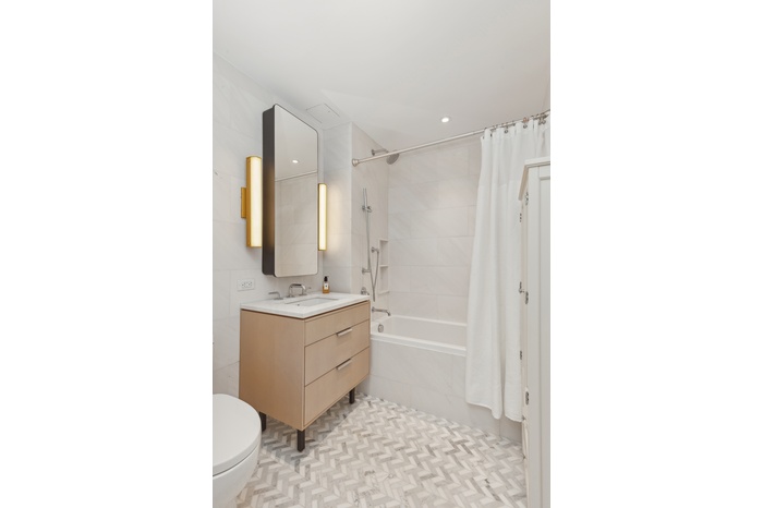 181 18th Street, Unit 301 Brooklyn, NY 11215 - Photo 5 of 13 a bathroom with a sink a mirror and a bathtub