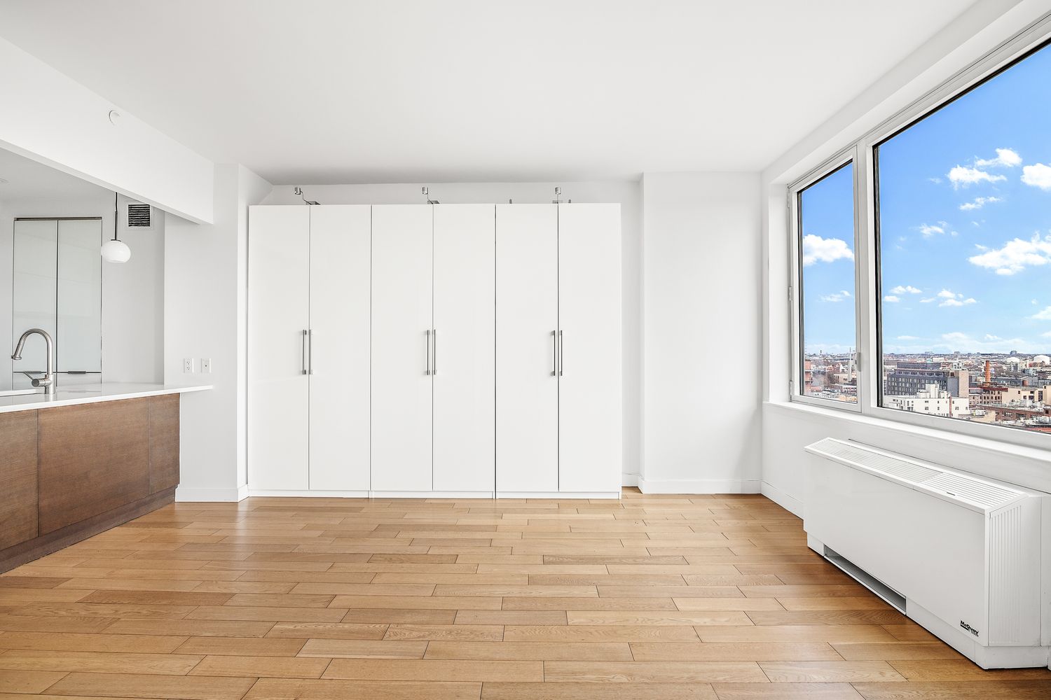 22 North 6th Street, Unit 19I Brooklyn, NY 11249 - Photo 2 of 3 a view of a room with a ceiling fan and window