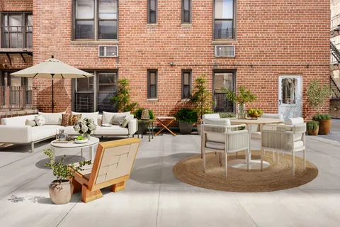 a view of a patio with dining table and chairs and potted plants