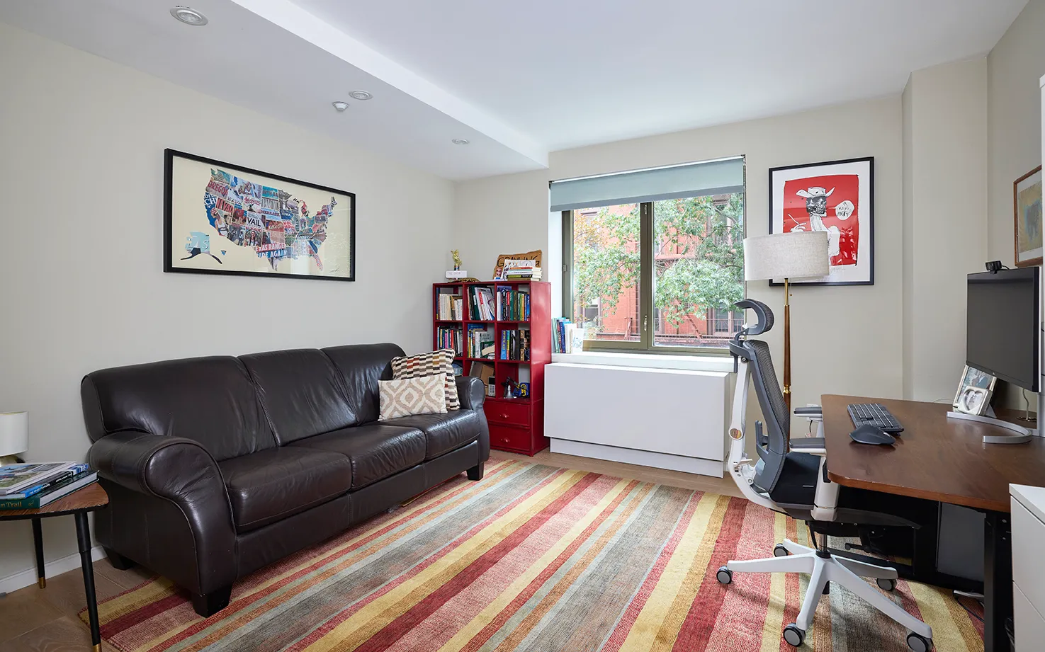 a living room with furniture and a flat screen tv with wooden floor