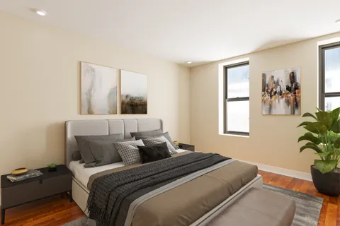 a bedroom with a bed and a potted plant