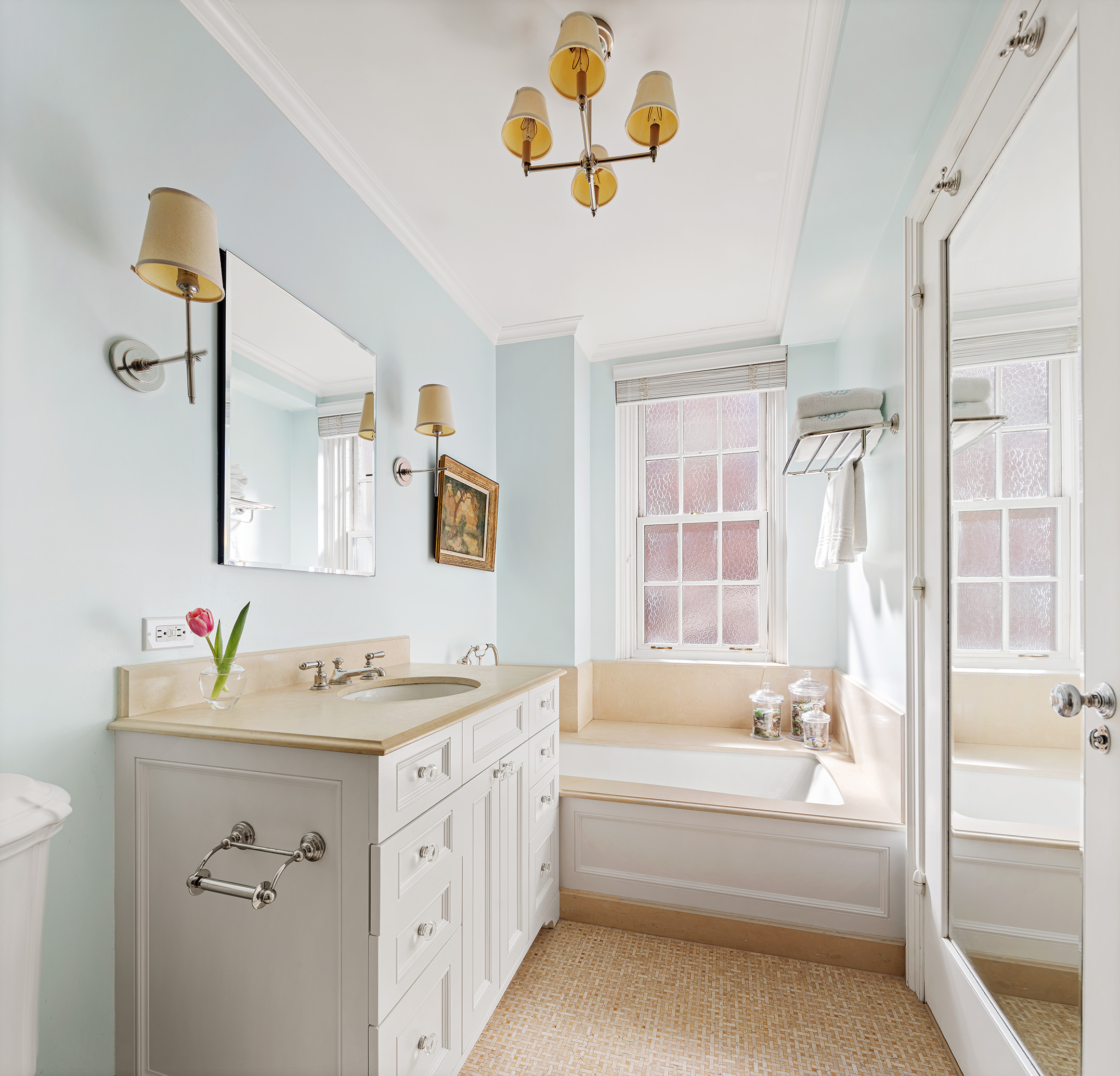 133 East 80th Street, Unit 3A Manhattan, NY 10075 - Photo 7 of 19 a bathroom with a sink a tub and a mirror