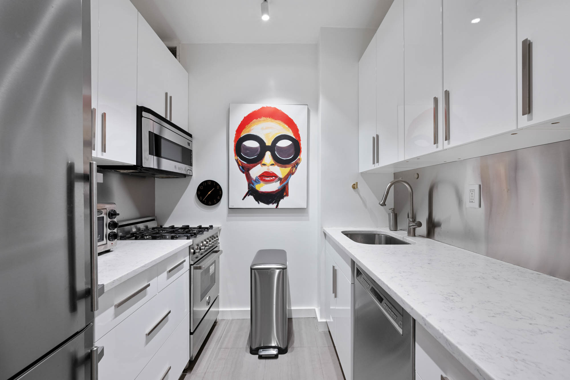 200 East 69th Street, Unit 2S Manhattan, NY 10021 - Photo 3 of 6 a kitchen with stainless steel appliances granite countertop a sink and a stove