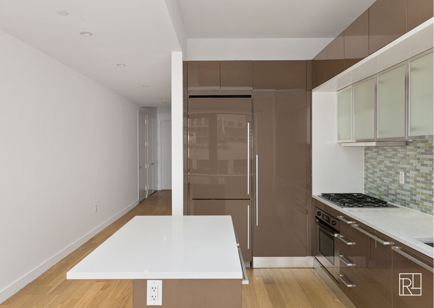 75 Wall Street, Unit 28D Manhattan, NY 10005 - Photo 16 of 35 a kitchen with a refrigerator and a stove top oven