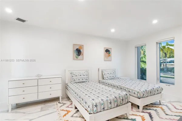 a bedroom with a large bed and a window