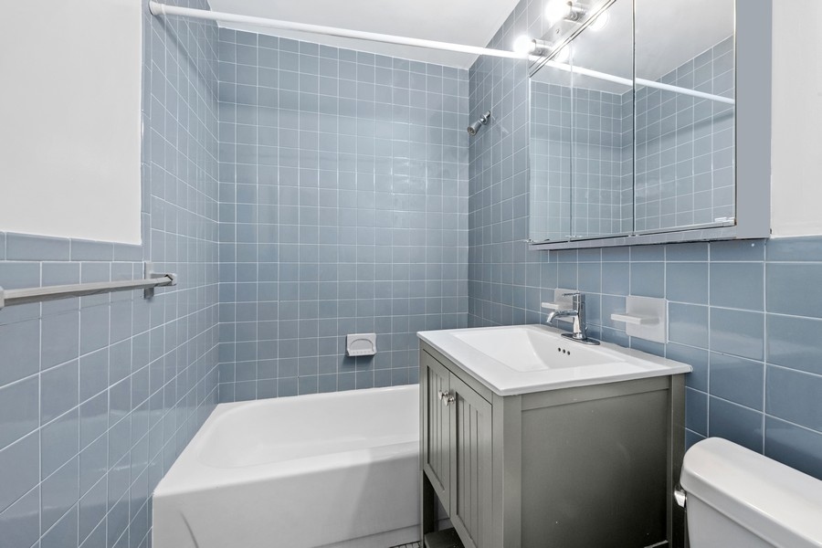 67 Hudson Street, Unit 4C Manhattan, NY 10013 - Photo 6 of 9 a bathroom with a sink a toilet and shower