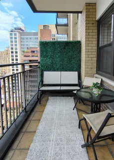 a balcony with table and chairs